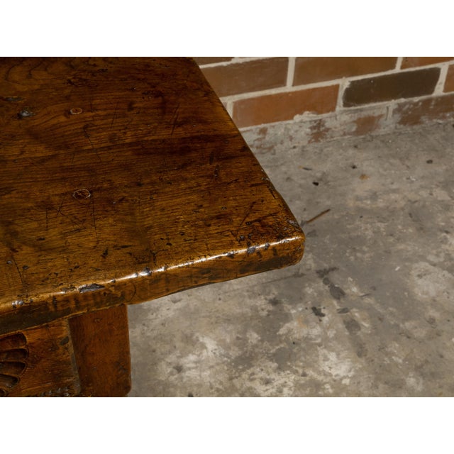 A French walnut desk from the early 19th century with three drawers, carved motifs, H-Form cross stretcher and nice...