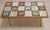Here's a wonderful coffee table that was custom made in Brazil circa 1960s. It features abstract tiles and gold metal...