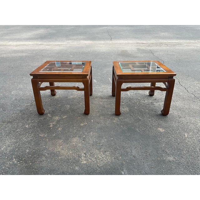 A sophisticated pair of vintage Chinese Chippendale–style end tables, crafted in richly finished hardwood with inset...