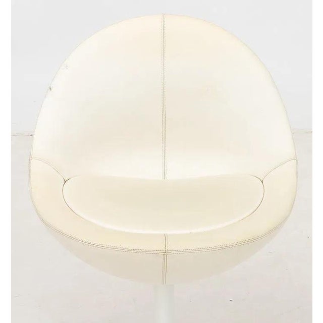 Borje Johanson "Venus" Swivel Chair, 1960s, with white leather upholstered seat above white patinated metal tulip base,...