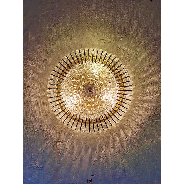 Impressive ceiling light by Ernst Palme / Palwa dating from about 1970, with a multitude of glass shapes on a gilt brass...