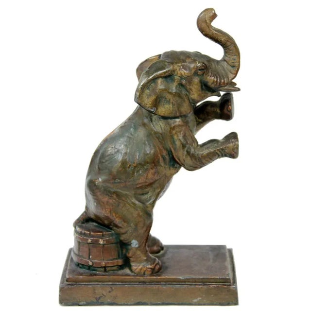 Add a charming touch to your decor with this whimsical sitting elephant statue with great detailing from the early...