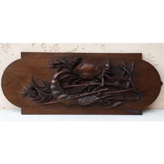An Asian fine carved wood wall plaque possibly Japonese with a crab, a lobster on bamboo.