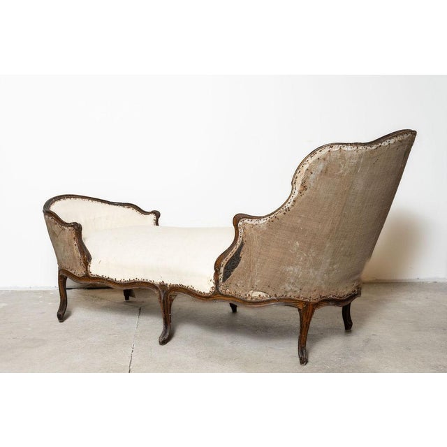 A rare French Louis XV duchesse en bateau chaise longue, believed to date to the late 18th century. This elegant reclining...
