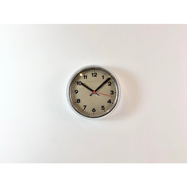 Vintage wall clock manufactured by PragUr in former Chechoslovakia in 1940 during second world war. It features a metal...