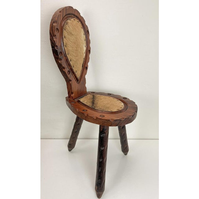 Beautifully designed tripod chair or stool made of sculptured wood and goat skin. Looks very good in a brutalist,...