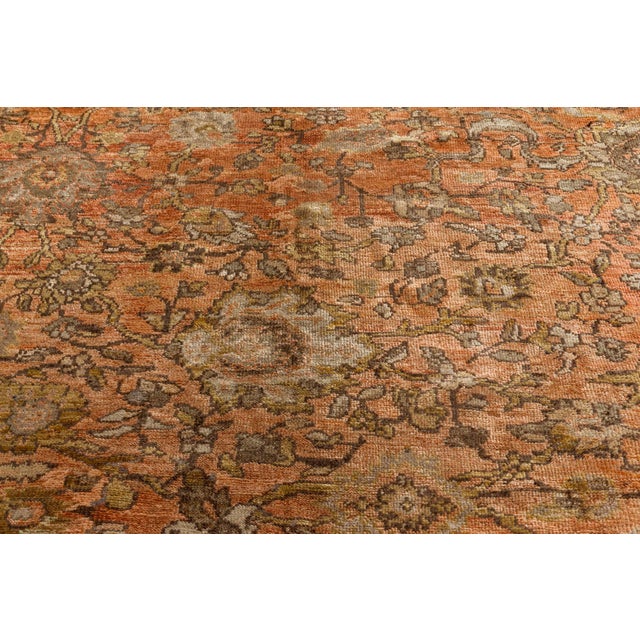 An early 20th century antique Sultanabad rug from West Persia, the abrashed rust field with palmettes, flowering vines and...