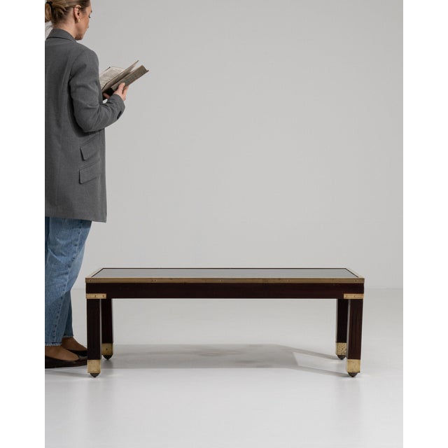 This table makes its impression through dark ebonized wood, fluted with brass cap foot. It was made in France during...