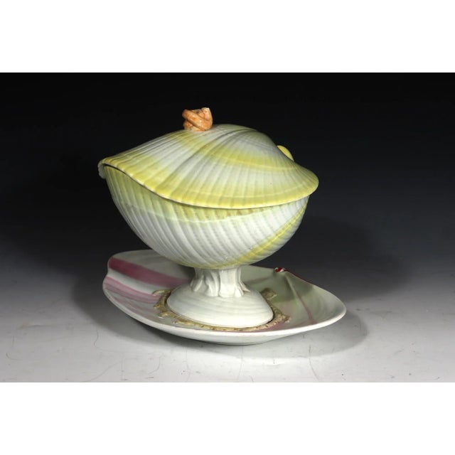 Wedgwood Pearlware Nautilus Sauce Tureen, Cover and Stand in Yellow and Pink Circa 1800–1815 This Wedgwood pearlware sauce...