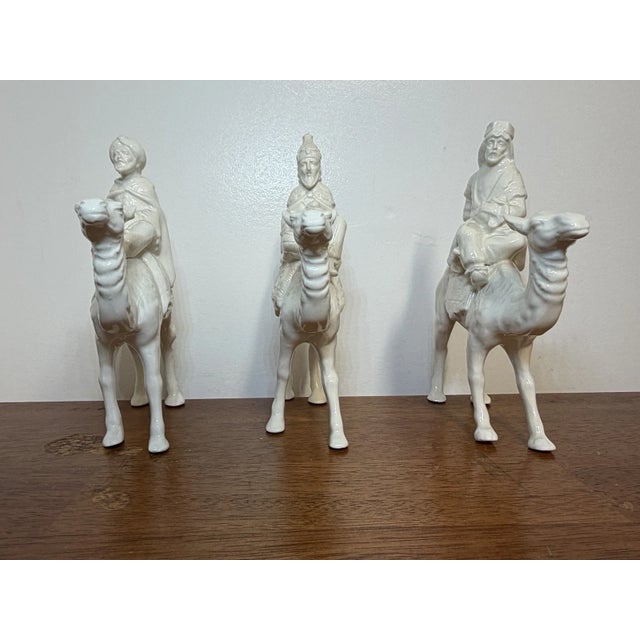 Set of 3 vintage-style white ceramic Three Wise Men riding camels. Detailed sculptural design with an elegant monochrome...