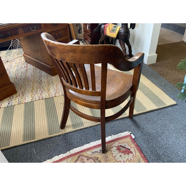 Circa 1930’s vintage Courthouse armchair, solid walnut. Labeled by the maker, Gunlocke Furniture Company, also with a...