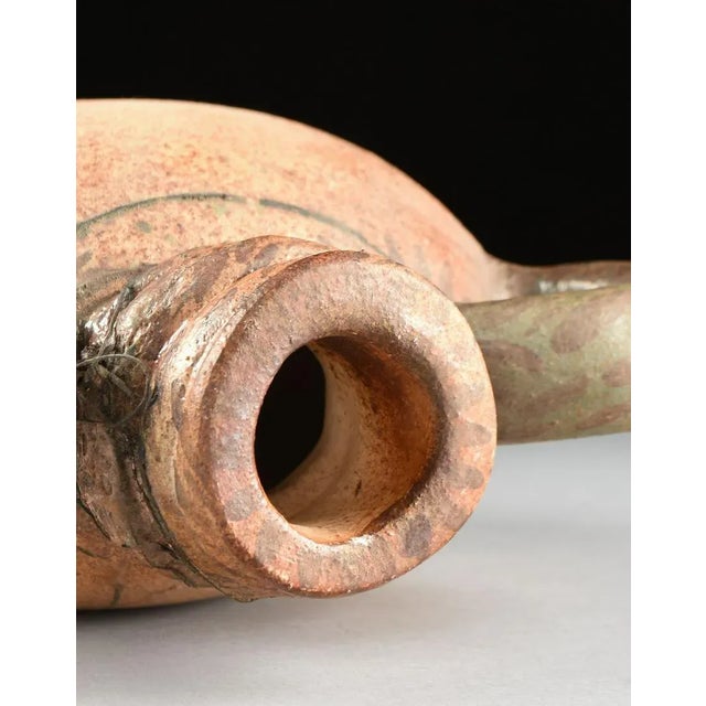 DENNIS W. SMITH American San Antonio, Texas A salt glazed two handled amphora form vase with coiled neck, the handles with...