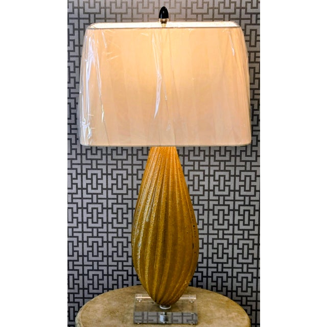 A striking vintage Murano-style gold art glass table lamp featuring an elongated teardrop silhouette, sweeping twisted...