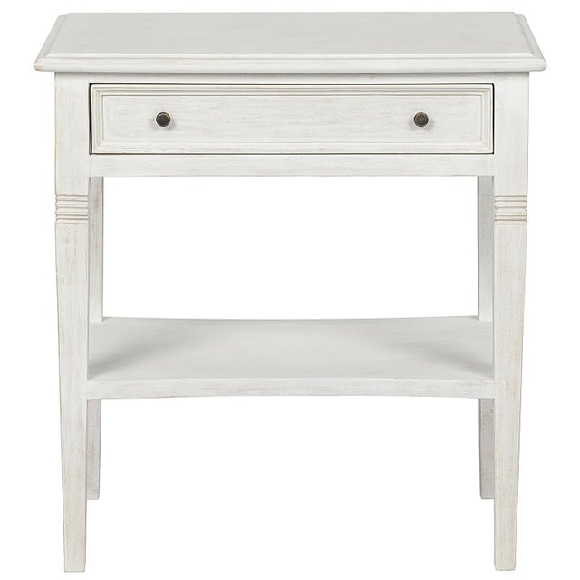 Intriguing design elements, like decorative carving atop tapered legs and a single slim drawer, elevate the traditionally...