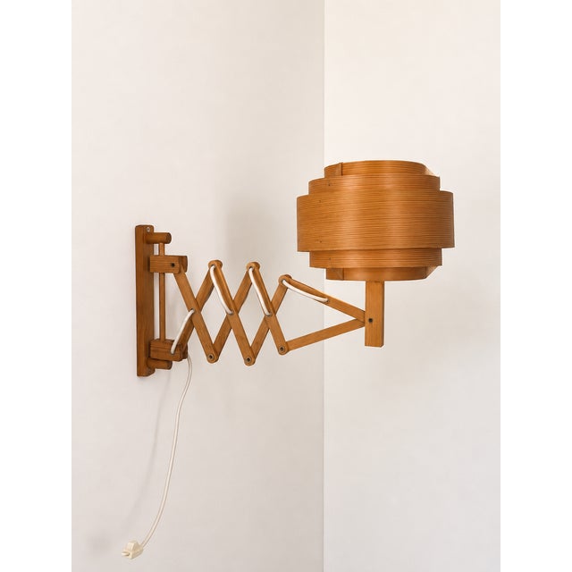 Wall sconce made of pine slats, produced in Sweden in the 1970s. Extendable wall sconce by Hans Agne Jakobsson, soft and...
