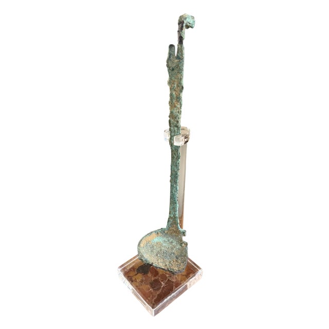 A rare Etruscan cast-bronze simpulum (ceremonial ladle), Italy, circa 6th century BCE, distinguished by its elongated...