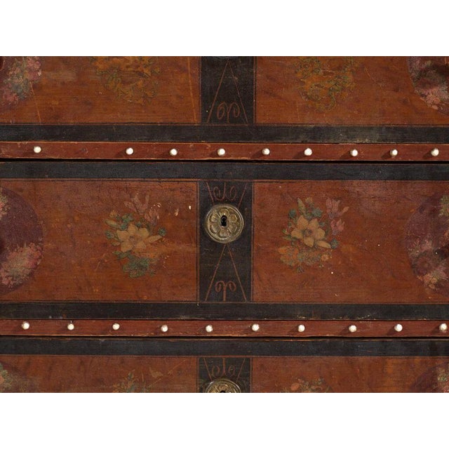 This antique painted folk chest of drawers in wood with four drawers, polychrome floral and religious decoration,...