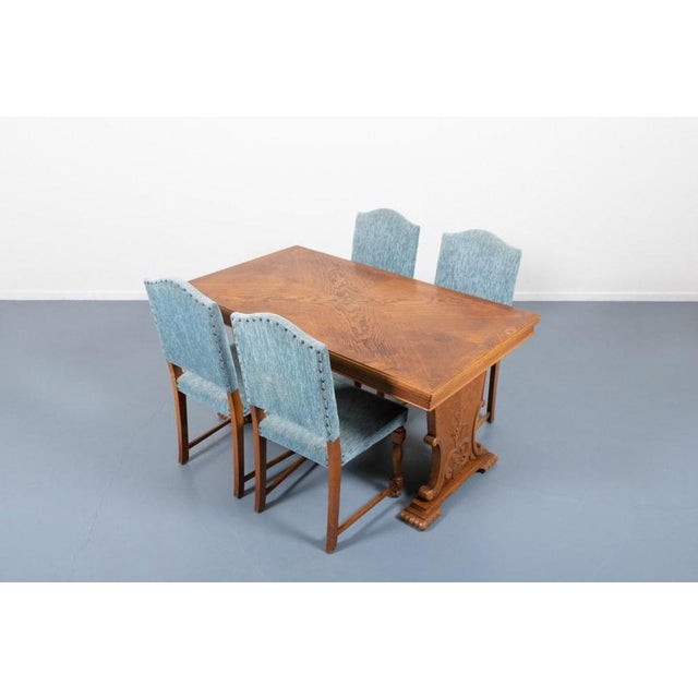 Varnished oak dining set of six chairs with blue upholstery and a table with extension leaves on the sides. Produced in...