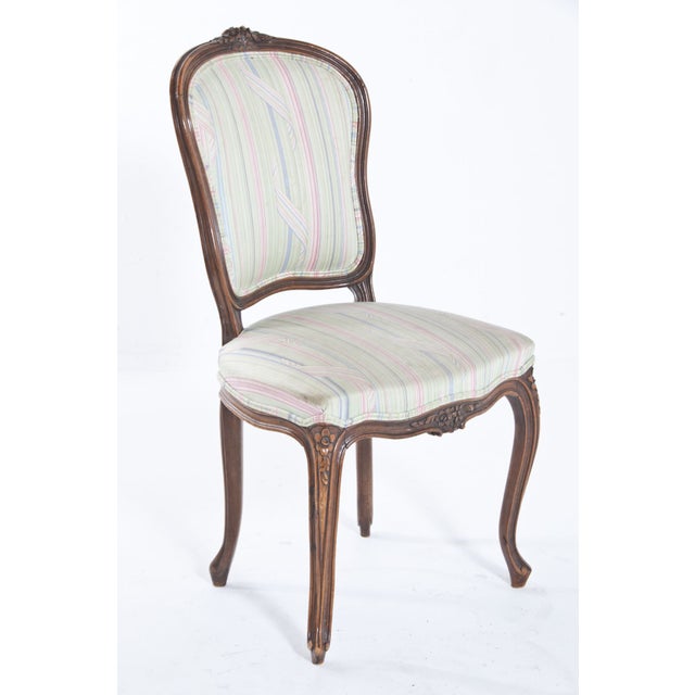 French chair with carved details to top rail and seat, having cabriolet legs.