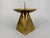 A candle holder * Made of brass * with an engraved Madonna and Child motif * Pyramidal base * Wide, round drip tray for...
