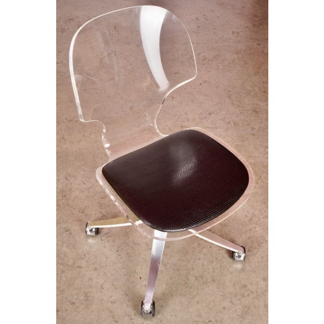 Brilliantly clear Lucite and a rolling aluminum based swivel office chair by Hill Manufacturing.This is a stunning and...