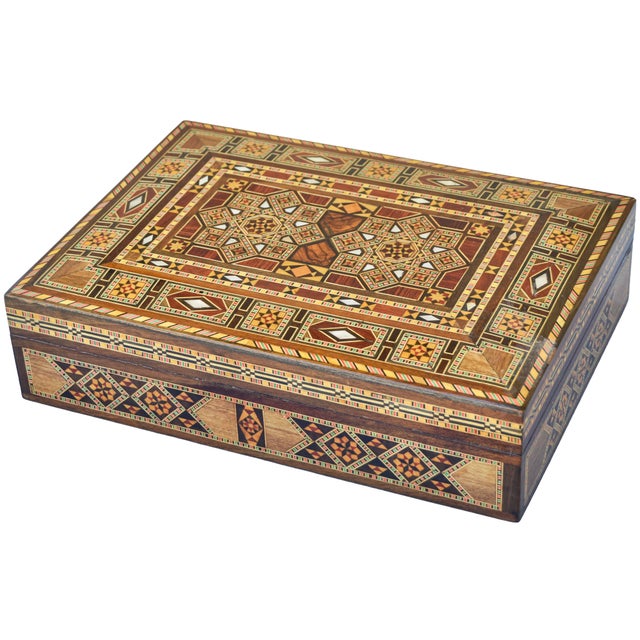 Stunning Mid-Century box thoughtfully handcrafted and inlaid using walnut, mahogany and various exotic wood, and...