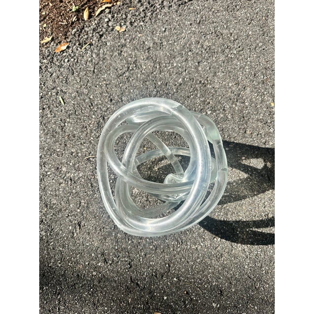 Oversized lucite knot sculpture. Fabulous on a bookcase, built-ins, or displayed on a coffee table on a stack of books.