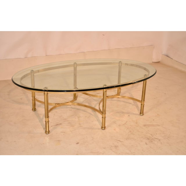 Mid-century brass coffee table with glass top from the 1960's. The glass top has beveled edges and normal wear and slight...