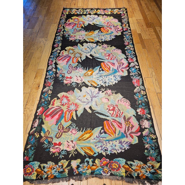 Vintage Caucasian Karabagh kilim in floral pattern from the early 1900s. The Karabagh kilim has a floral pattern in the...