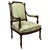 An elegant 19th century French open armchair, finely crafted in walnut and distinguished by its graceful proportions,...