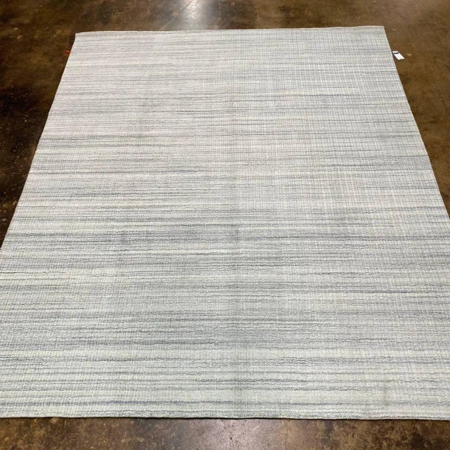ACTUAL SIZE: 8'2" X 9'8" PRIMARY COLOR: Gray / Ivory AGE: New ORIGIN: India MATERIALS: Wool FOUNDATION: Cotton PRODUCTION:...