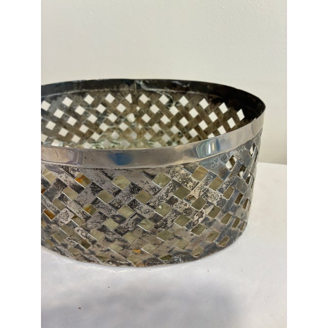 A vintage silverplate oval basket by International Silver Company featuring an elegant pierced lattice design and classic...