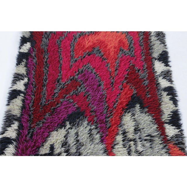 Hand-knotted in lush, high-pile wool in Sweden circa 1960-1970, this 3x5 vintage Swedish Rya rug is a bold new addition to...