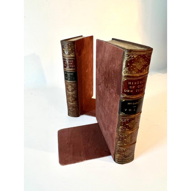 Bookends comprised of two ends that look like books. The pieces are not actually books, but look like leather bound books....