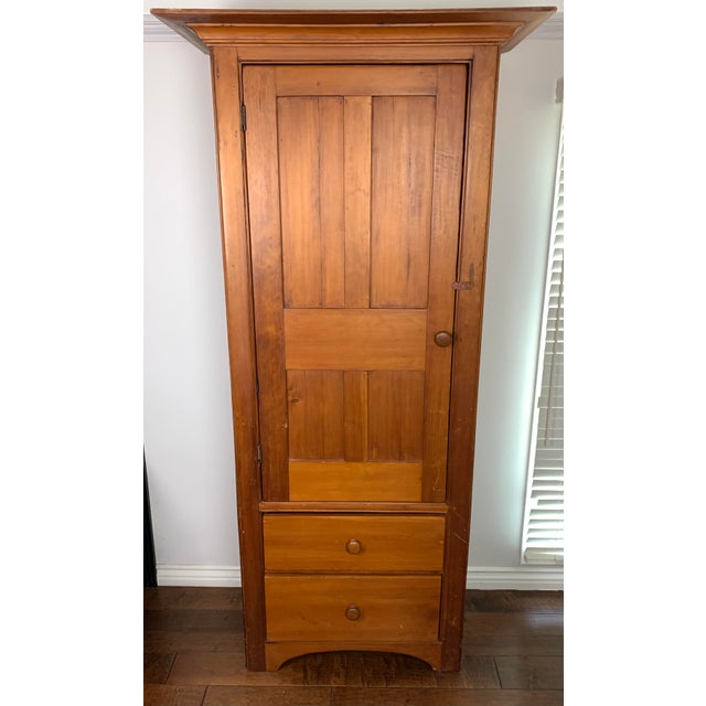 Mid 19th century Canadian pine chimney cupboard from Perth Canada, circa 1860. Upper paneled door with one interior shelf....