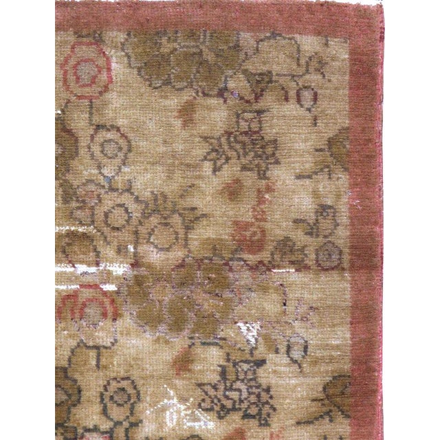 This mid-20th-century Turkish Anatolian throw rug presents a softly layered floral composition across a warm sand and...