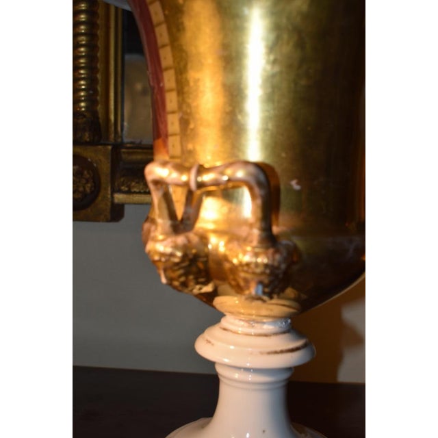 Old Paris porcelain urn circa 1830 to 1840. The face of this graceful urn form shows a warm family scene amongst...