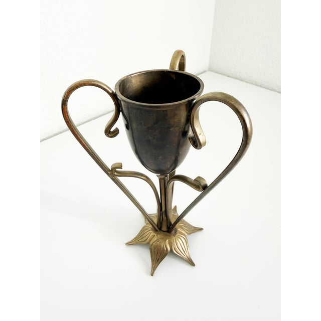 Vintage vessel or bud vase featuring three sinuous arms and a flower petal base, giving the piece an Art Nouveau feel....