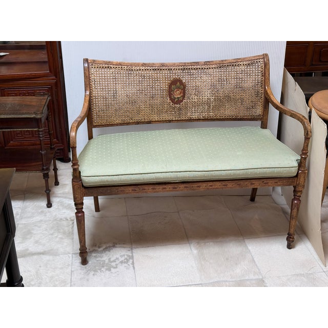 Design Plus Gallery presents a Caned Bench with Seat Cushion in the Regency Style. This is a classic small sofa with beech...