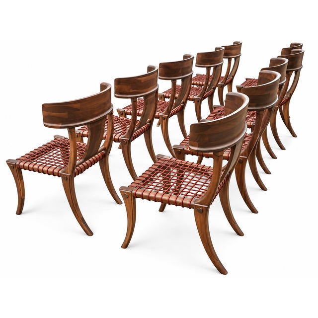Klismos solid walnut dining chairs. The chairs are made of solid walnut with a satin finish and leather cording. The...