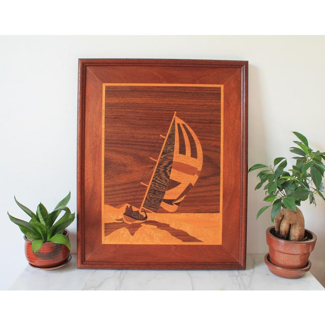 Vintage framed handmade marquetry picture features wood inlay artwork of people in a sailboat. No makers mark. Minor age...
