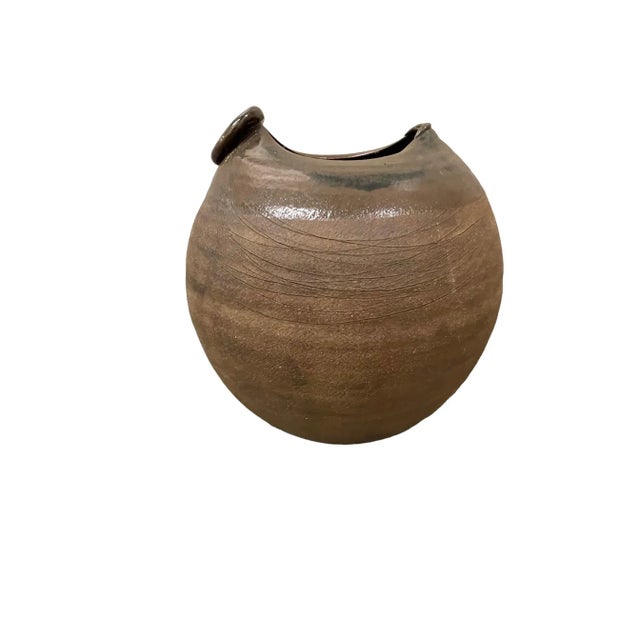 A large ceramic vase with strong textured exterior surface and glazed interior. As a result of the production process each...