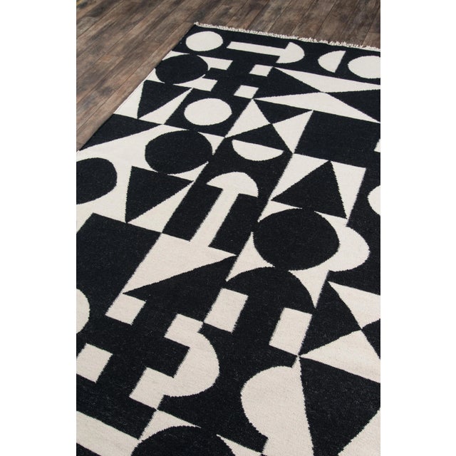 Classic motifs meet contemporary symmetry in the modern style of this handmade area rug collection. Repeating geometric...