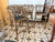 A stylish set of four vintage bamboo stools featuring an elegant open fretwork back, wrapped bamboo joints, and black...