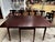 Solid mahogany drop leaf table with two arm chairs and five regular chairs. Seats have needle point embroidery. Built in...