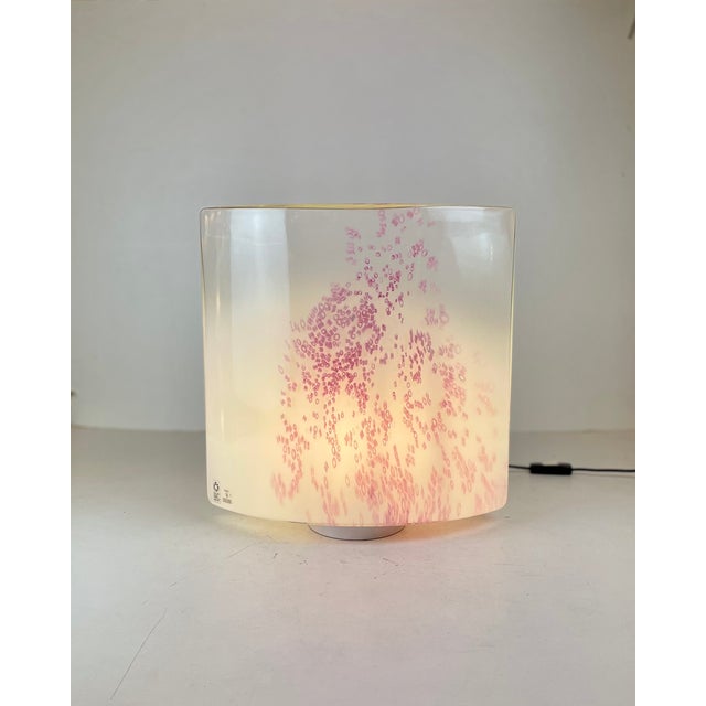 Large italian table lamp in clear to white gradient murano glass with small blurred pink murine incrusted on the front...