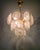 Brass chandelier with 18 Murano glass discs, Italy, 1970s. Each disc is clear with a frosted effect in the center and...