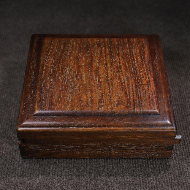 A beautifully crafted Chinese hardwood box, likely made of Huali (rosewood). This square box features a clever sliding...