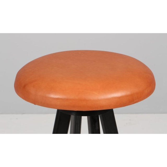 Hans Olsen bar stool with rotable seat of new upholstered full grain aniline leather. Frame of solid black painted wood....