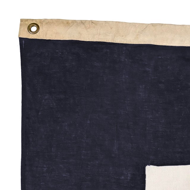 This vintage signal flag has been modified to a different size and shape. Made from a cotton cloth in navy blue and off...